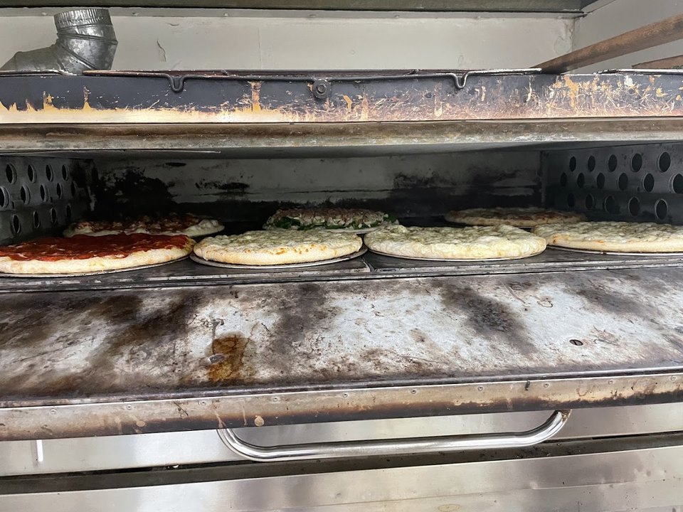 Stone-cooked pizza served in a casual dining room.