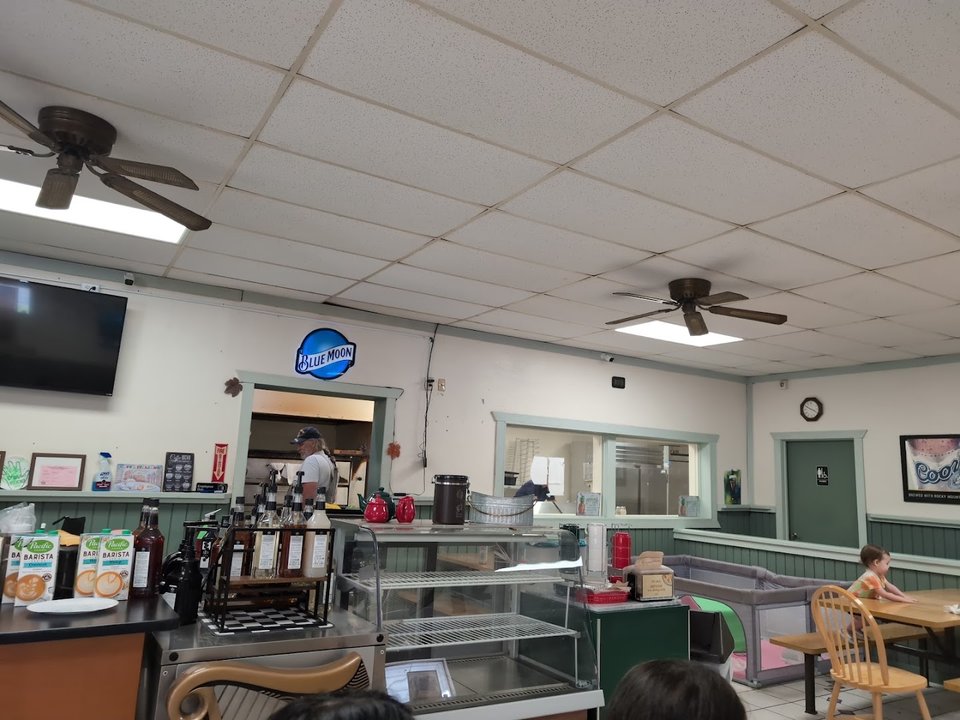Family-friendly tables inside a large pizza restaurant.
